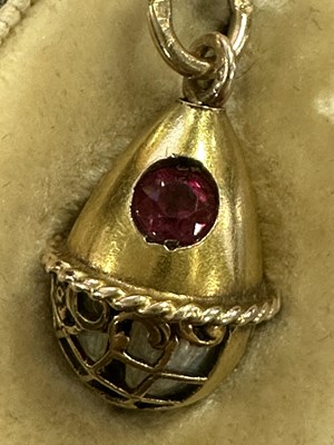 Lot 274 - A LATE 19TH CENTURY FABERGE 14CT GOLD ENAMEL AND RUBY PENDANT EGG, WORKMASTER HENRIK WIGSTROM