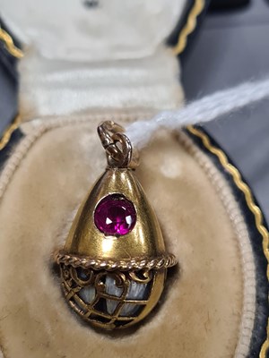 Lot 274 - A LATE 19TH CENTURY FABERGE 14CT GOLD ENAMEL AND RUBY PENDANT EGG, WORKMASTER HENRIK WIGSTROM