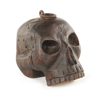 Lot 683 - A 19TH CENTURY GERMAN CARVED MEMENTO MORI SKULL DOOR STOP