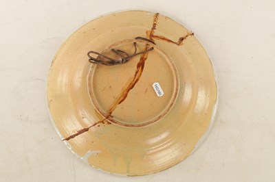 Lot 29 - A LATE 19TH CENTURY POLYCHROME PAINTED SHALLOW POTTERY DISH