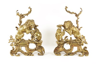 Lot 519 - A PAIR OF REGENCY ORMOLU CHENETS OF ROCOCO DESIGN