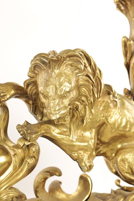 Lot 519 - A PAIR OF REGENCY ORMOLU CHENETS OF ROCOCO DESIGN