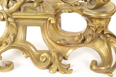 Lot 519 - A PAIR OF REGENCY ORMOLU CHENETS OF ROCOCO DESIGN