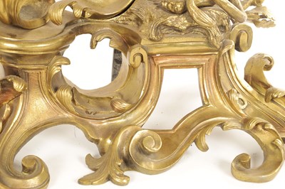 Lot 519 - A PAIR OF REGENCY ORMOLU CHENETS OF ROCOCO DESIGN