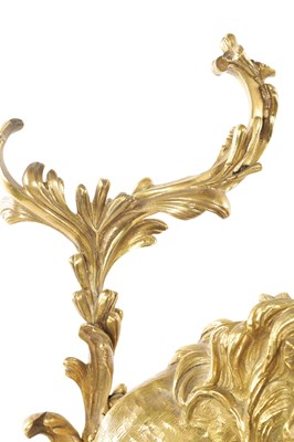 Lot 519 - A PAIR OF REGENCY ORMOLU CHENETS OF ROCOCO DESIGN