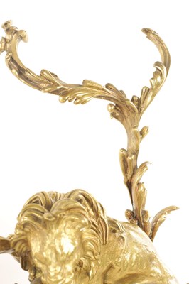 Lot 519 - A PAIR OF REGENCY ORMOLU CHENETS OF ROCOCO DESIGN