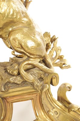 Lot 519 - A PAIR OF REGENCY ORMOLU CHENETS OF ROCOCO DESIGN