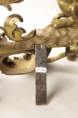 Lot 519 - A PAIR OF REGENCY ORMOLU CHENETS OF ROCOCO DESIGN