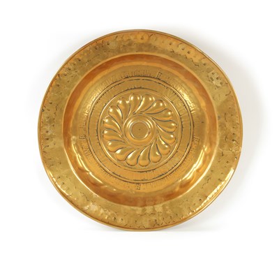 Lot 532 - A 17TH CENTURY BRASS ALMS DISH