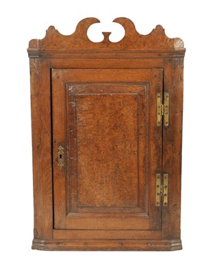 Lot 1288 - A RARE EARLY 18TH CENTURY BURR OAK PANELLED CORNER CUPBOARD OF SMALL SIZE