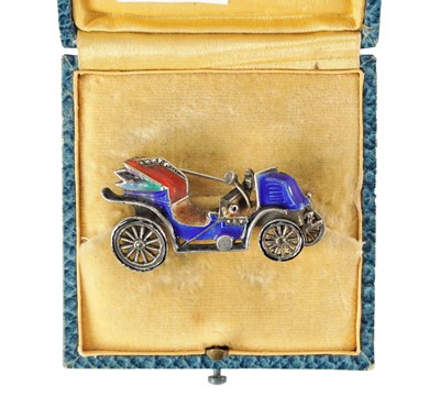 Lot 67 - A VINTAGE SILVER ENAMEL CAR BROOCH