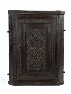 Lot 8 - A 19TH CENTURY CARVED OAK HANGING CORNER CUPBOARD