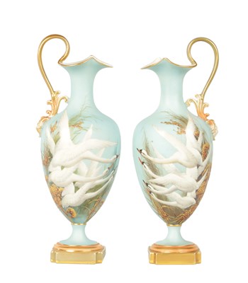 Lot 62 - CHARLES H C. BALDWYN A FINE PAIR OF ROYAL WORCESTER RICHLY GILT AND SKY BLUE GROUND OVOID EWERS WITH SCROLL HANDLES