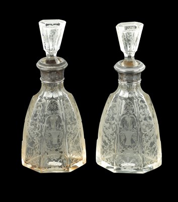 Lot 677 - A NEAR PAIR OF 19TH CENTURY SILVER TOPPED CUT GLASS DECANTERS