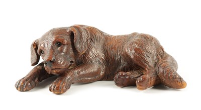 Lot 1053 - A 19TH CENTURY BLACK FOREST CARVED LINDEN WOOD DOG SCULPTURE