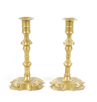 Lot 876 - A PAIR OF MID 18TH CENTURY SEAMED CAST BRASS CANDLESTICKS