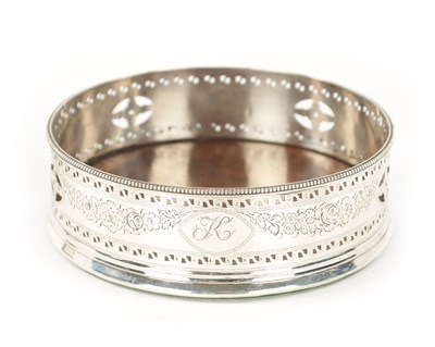Lot 737 - A GEORGE III SILVER BOTTLE COASTER