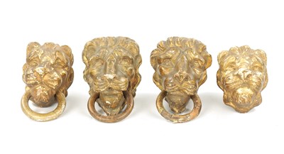 Lot 46 - A SET OF FOUR REGENCY CARVED GILTWOOD LION'S HEADS
