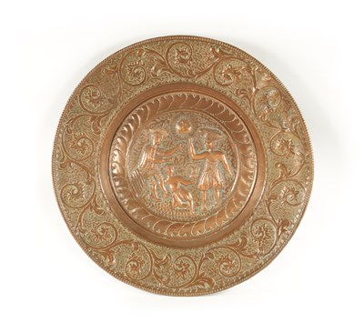 Lot 384 - A 16TH / 17TH CENTURY EMBOSSED COPPER ALMS DISH OF LARGE SIZE