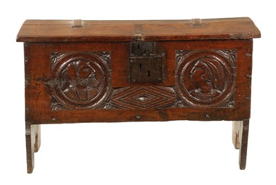 Lot 316 - AN IMPORTANT 17TH CENTURY CARVED OAK PLANK COFFER WITH CARVED ROMANESQUE HEADS