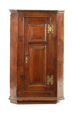 Lot 141 - AN EARLY 18TH CENTURY OAK PANELLED HANGING CORNER CUPBOARD