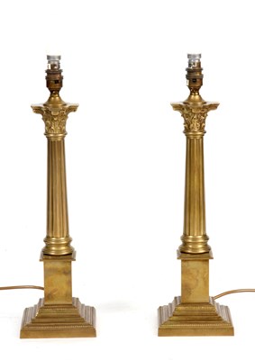 Lot 554 - A PAIR OF BRASS CORINTHIAN LAMPS 47cm high.