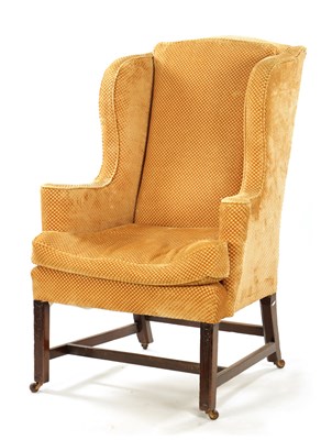 Lot 102 - A GEORGE III STYLE MAHOGANY WING BACK UPHOLSTERED ARMCHAIR