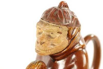 Lot 476 - A 19TH CENTURY POTTERY MONKEY PITCHER JUG