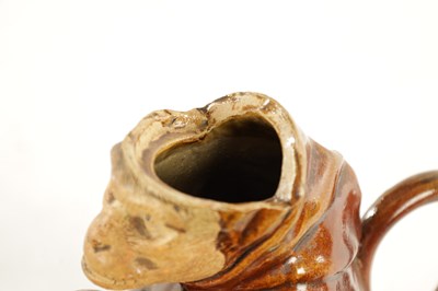 Lot 476 - A 19TH CENTURY POTTERY MONKEY PITCHER JUG