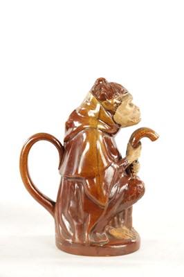 Lot 476 - A 19TH CENTURY POTTERY MONKEY PITCHER JUG
