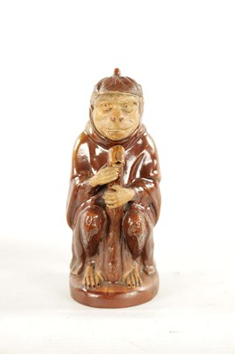 Lot 476 - A 19TH CENTURY POTTERY MONKEY PITCHER JUG