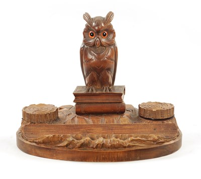 Lot 1064 - AN EARLY 20TH CENTURY CARVED FRUITWOOD BLACK FOREST INKWELL