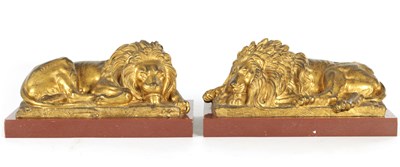 Lot 698 - A PAIR OF LATE 19TH CENTURY GILT BRONZE RECUMBENT LIONS
