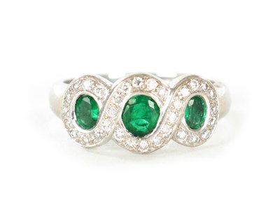 Lot 310 - A LADIES 18CT WHITE GOLD THREE STONE EMERALD AND DIAMOND RINGE