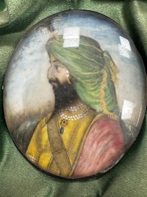 Lot 276 - A CASE GROUP OF NINETEEN PAINTED IVORY MINIATURE PORTRAITS OF THE INDIAN MAHARAJA OF PUNJAB