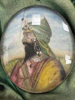 Lot 276 - A CASE GROUP OF NINETEEN PAINTED IVORY MINIATURE PORTRAITS OF THE INDIAN MAHARAJA OF PUNJAB