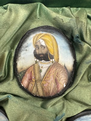 Lot 276 - A CASE GROUP OF NINETEEN PAINTED IVORY MINIATURE PORTRAITS OF THE INDIAN MAHARAJA OF PUNJAB