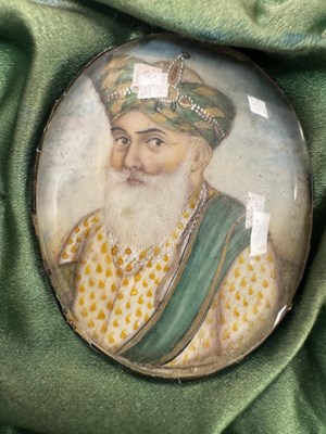Lot 276 - A CASE GROUP OF NINETEEN PAINTED IVORY MINIATURE PORTRAITS OF THE INDIAN MAHARAJA OF PUNJAB