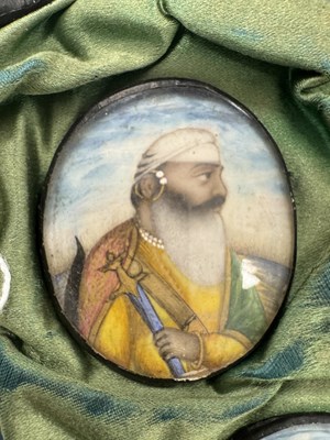 Lot 276 - A CASE GROUP OF NINETEEN PAINTED IVORY MINIATURE PORTRAITS OF THE INDIAN MAHARAJA OF PUNJAB