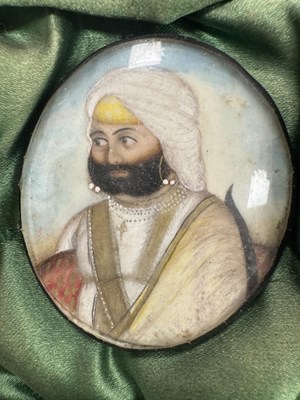 Lot 276 - A CASE GROUP OF NINETEEN PAINTED IVORY MINIATURE PORTRAITS OF THE INDIAN MAHARAJA OF PUNJAB