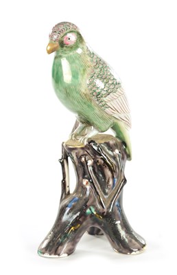 Lot 35 - A 19TH CENTURY CERAMIC PERCHED PARROT FIGURE