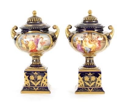 Lot 70 - A PAIR OF LATE 19TH CENTURY ROYAL BLUE AND GILT VIENNA STYLE LIDDED VASES