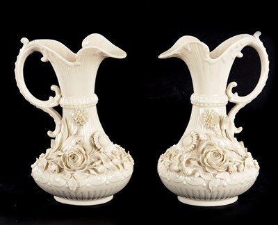 Lot 87 - A GOOD PAIR OF 19TH CENTURY BELLEEK, CO. FERMANAGH BLANC DI CHINE PORCELAIN EWERS