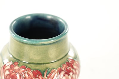 Lot 31 - A WILLIAM MOORCROFT MINIATURE 'WARATAH' CABINET VASE