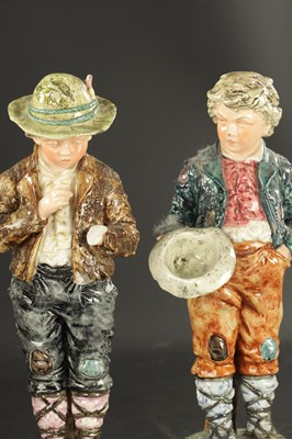 Lot 86 - A PAIR OF LATE 19TH CENTURY ROYAL DUX FIGURES OF BOYS