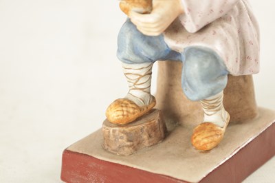 Lot 35 - A RUSSIAN IMPERIAL SEATED FIGURE OF A COBBLER