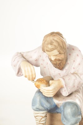 Lot 35 - A RUSSIAN IMPERIAL SEATED FIGURE OF A COBBLER