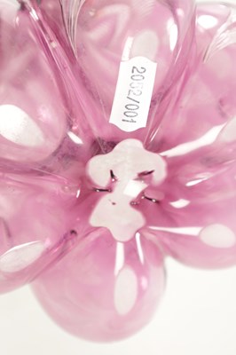 Lot 26 - ATTRIBUTED TO STEVENS AND WILLIAMS - AN INTAGLIO CUT GLASS AMETHYST TINTED DECANTER OF ORGANIC FORM OF 6 LOBES