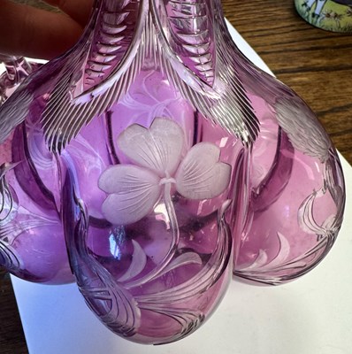 Lot 26 - ATTRIBUTED TO STEVENS AND WILLIAMS - AN INTAGLIO CUT GLASS AMETHYST TINTED DECANTER OF ORGANIC FORM OF 6 LOBES
