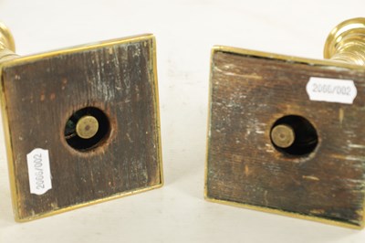 Lot 645 - A PAIR OF GEORGE III BRASS CANDLESTICKS